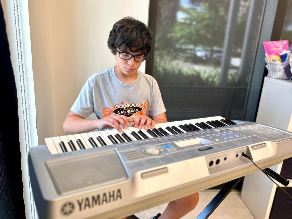 Juan, age 12 played the piano during the Teen Celebration